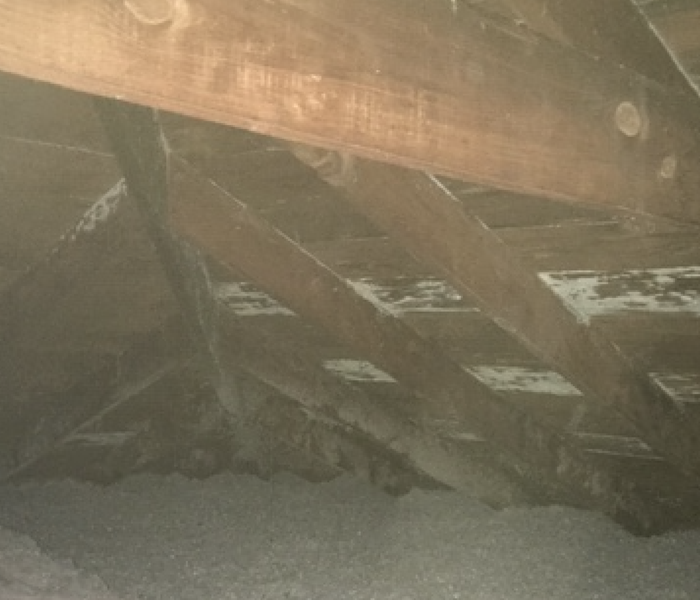 wood planks in an attic with grey and white discoloration