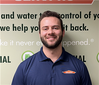 man in front of servpro signage