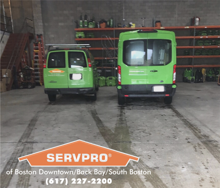 2 green vans in a warehouse